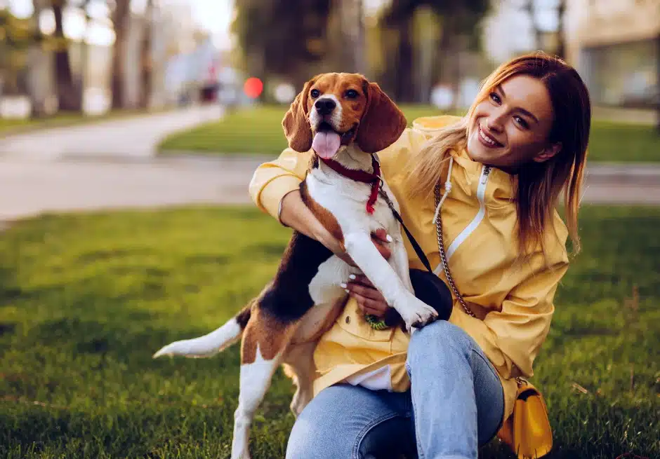 Woman holding her dog that has Bed breath